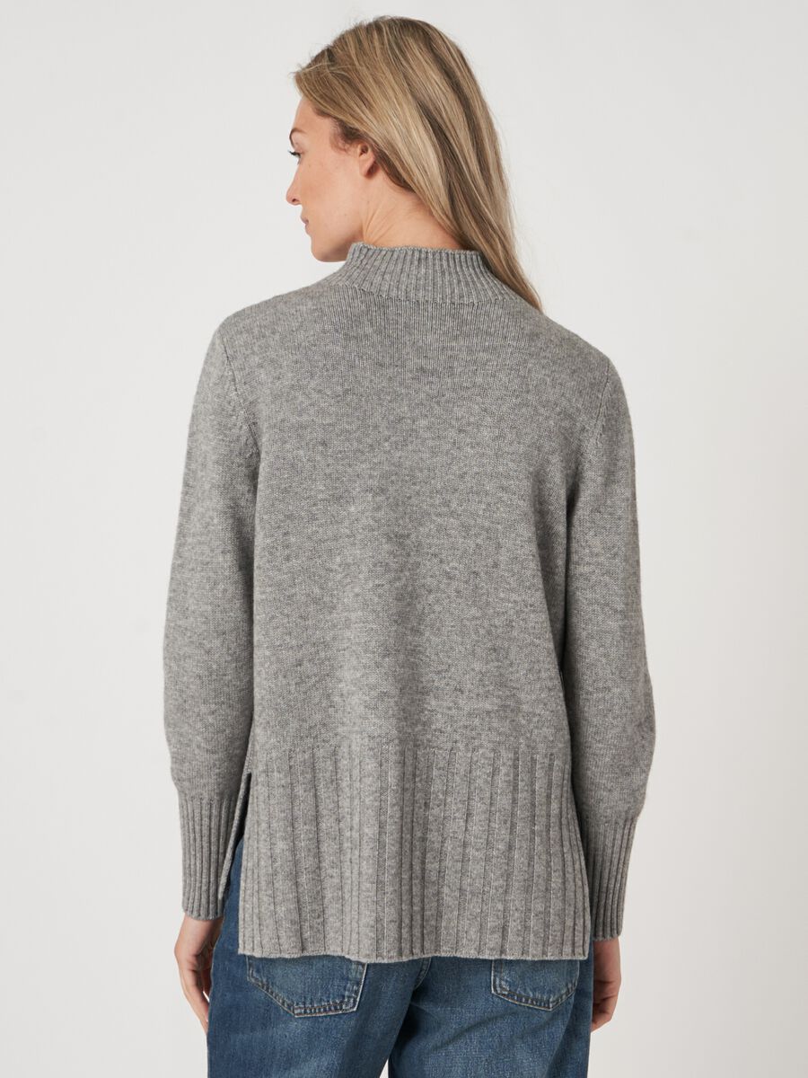 High neck cashmere blend sweater with cable knit detail and side slits