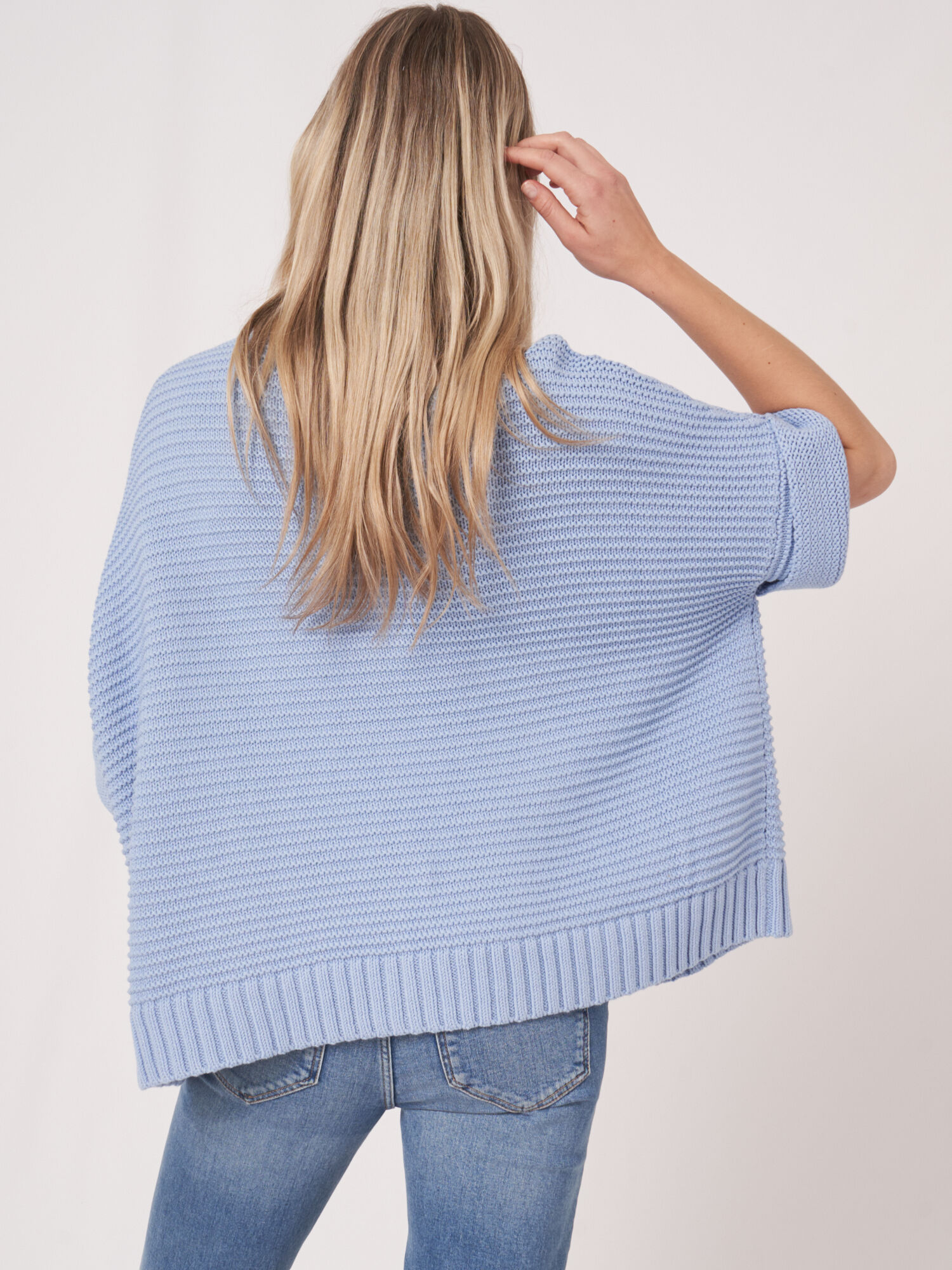 Knitted cotton poncho with zip and chunky rib texture