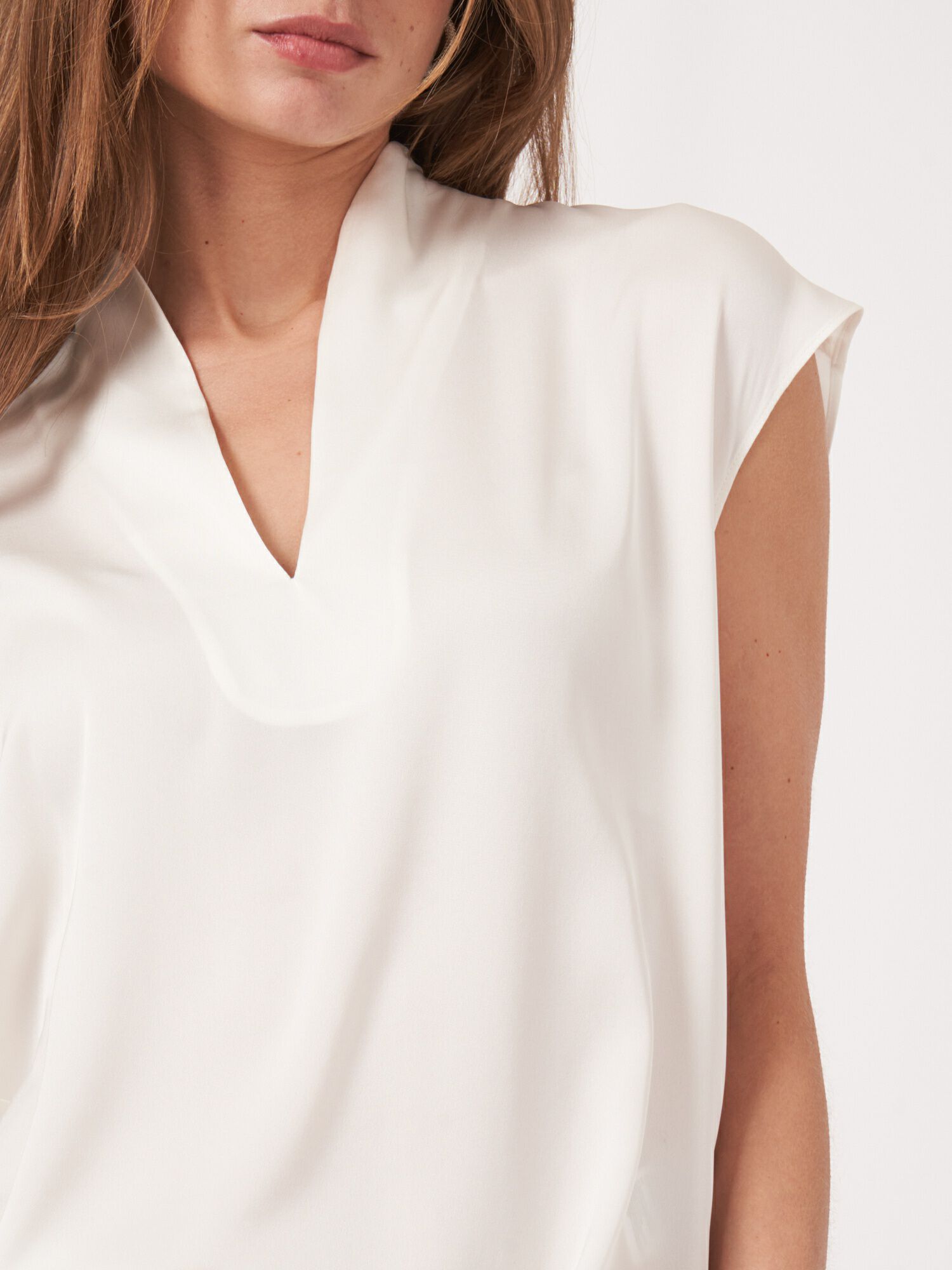 Sleeveless silk top with slit neckline